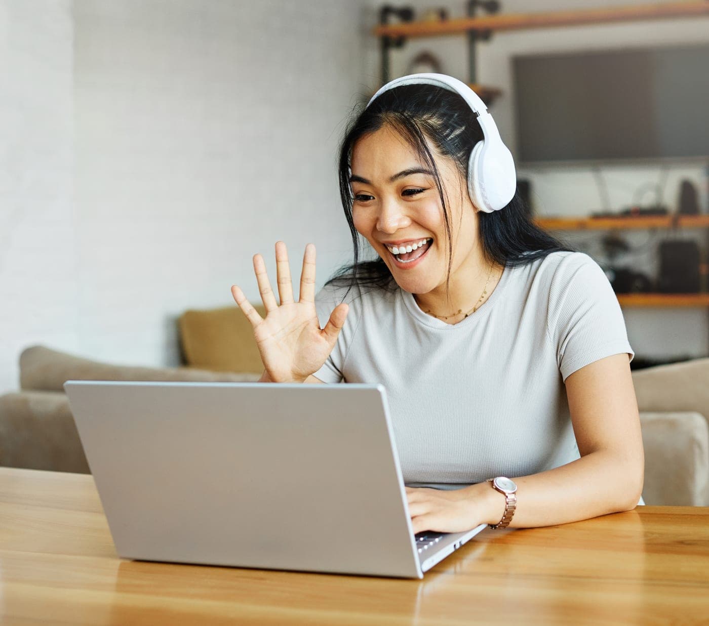 A team member on a relaxed video planning call from her desk